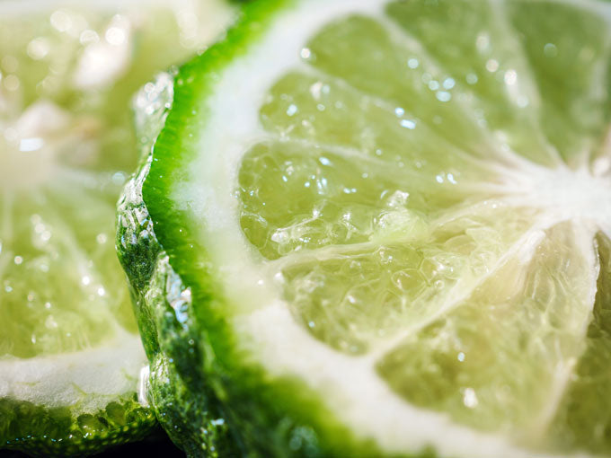 Close-up of sliced green lime with water droplets