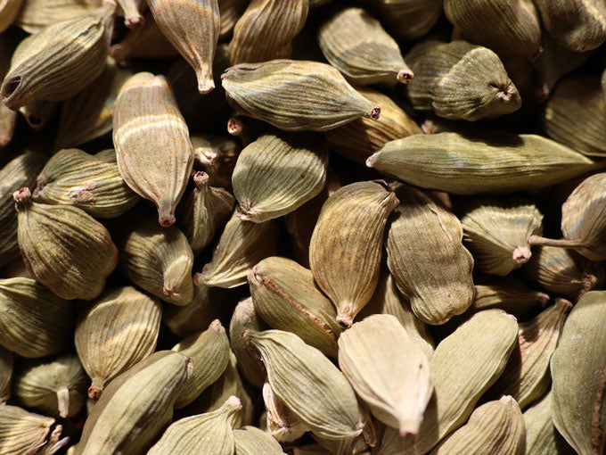 Close-up of cardamom pods with a focus on texture and color.